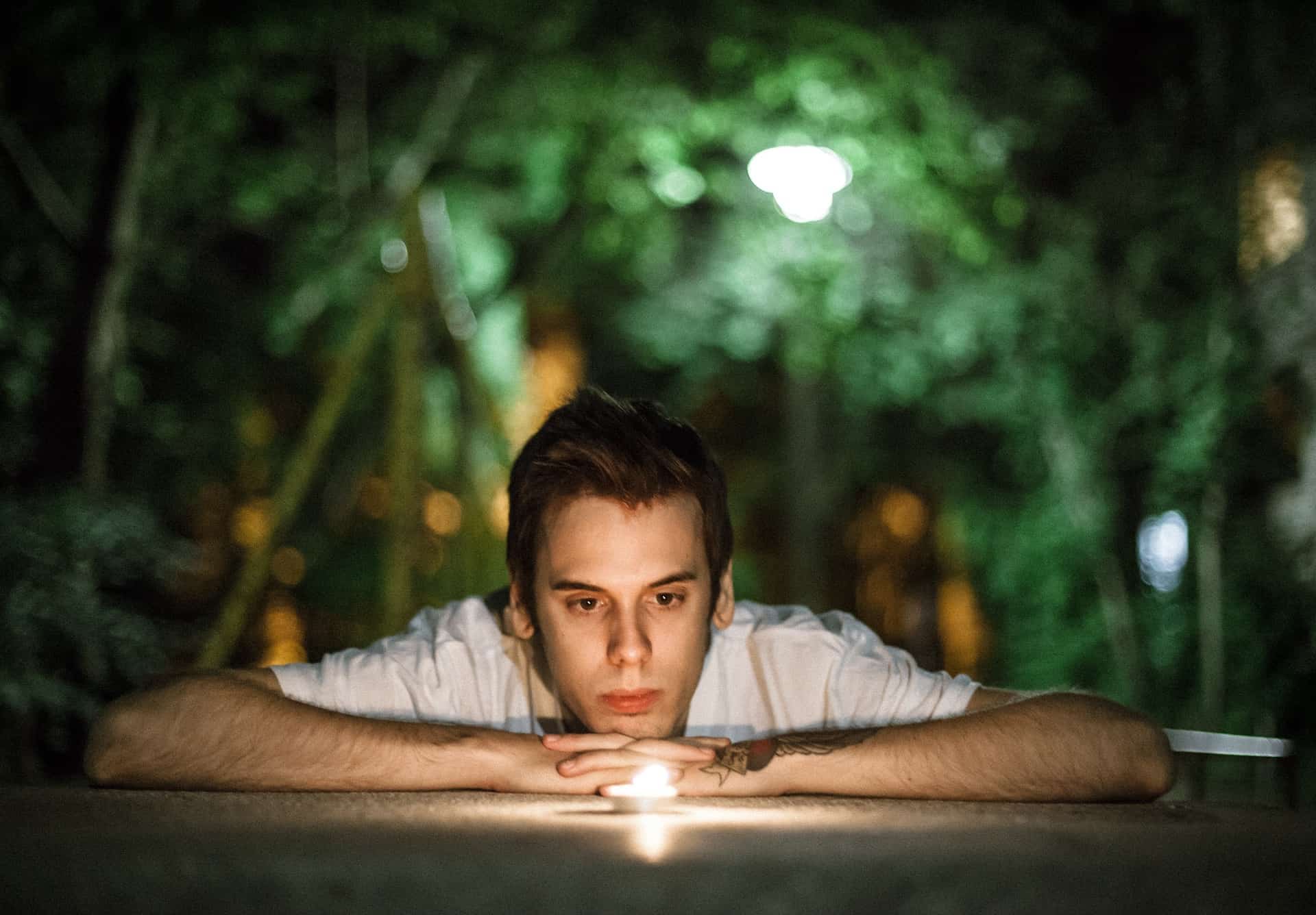 A person observing a candle with mindful awareness.